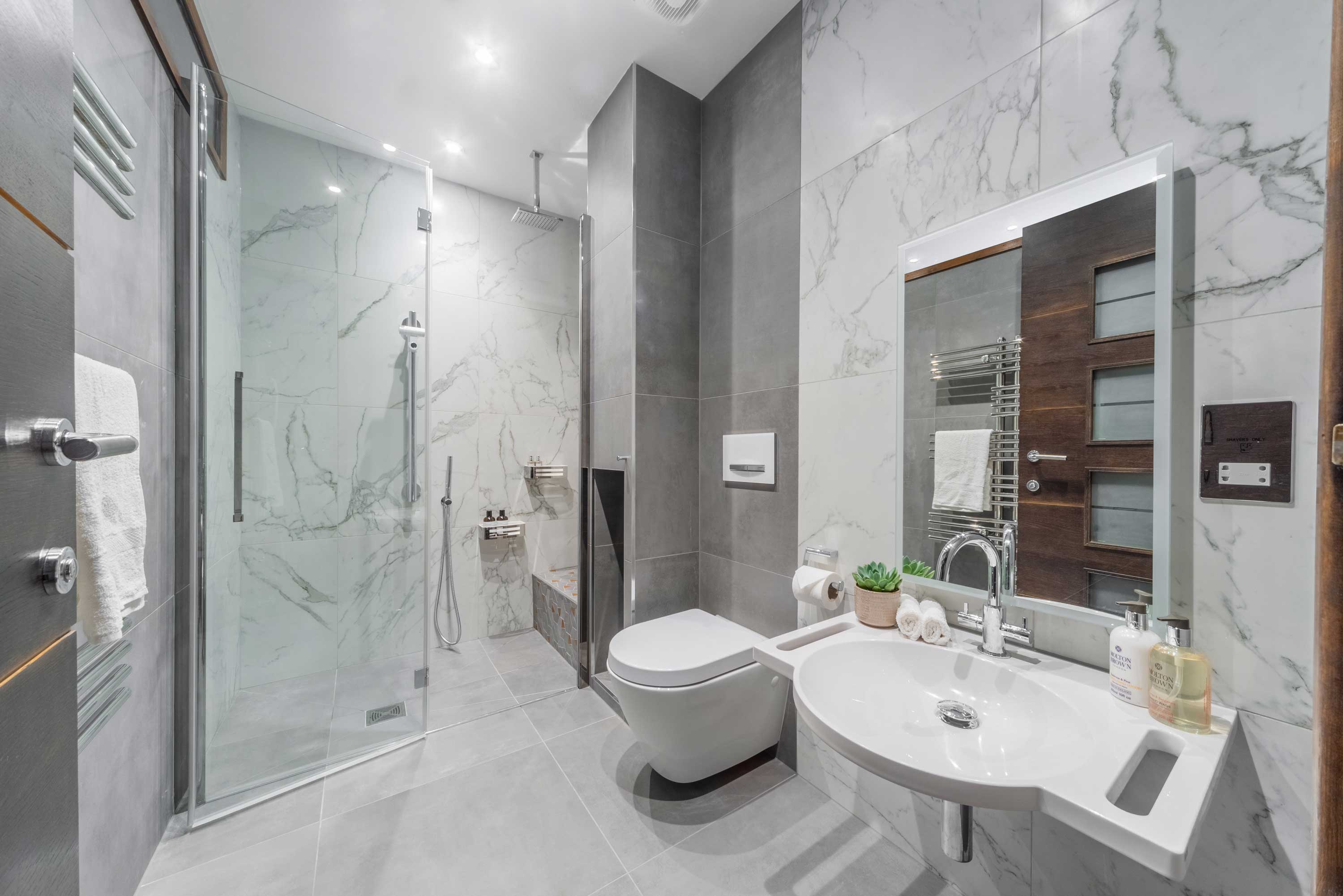 Grey marble Fine & Able accessible wetroom featuring shower bench