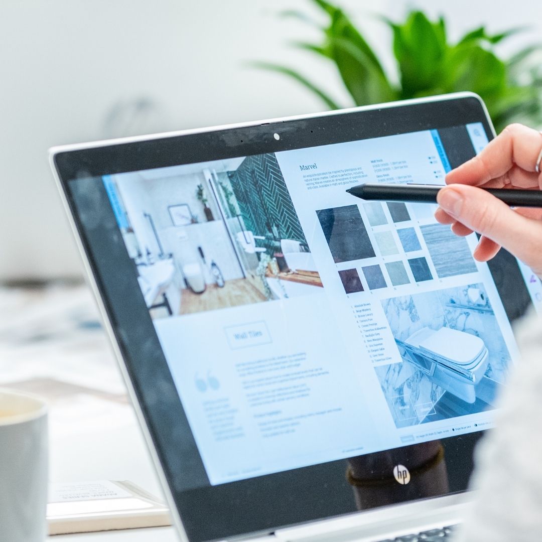 A person viewing a Fine & Able brochure on a tablet